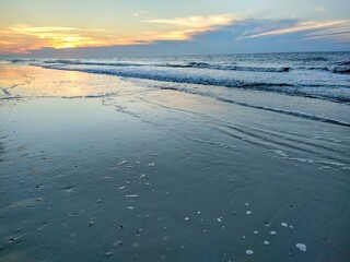 Receding Ocean Waves and Beach Sunrise