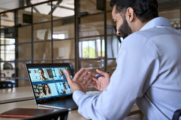 Indian happy smiling businessman ceo having working videocall on planning finance with multiracial...