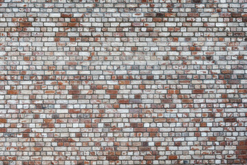 The wall is made of old bricks, background.