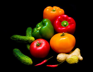 colorful healthy vegetables lie on a black background