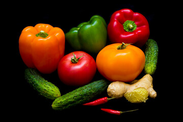 colorful healthy vegetables lie on a black background