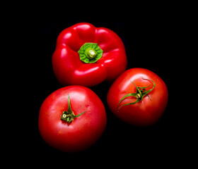 red vegetables lie on a black background