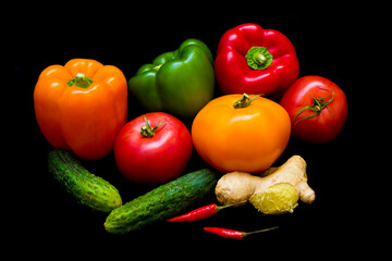 colorful healthy vegetables lie on a black background