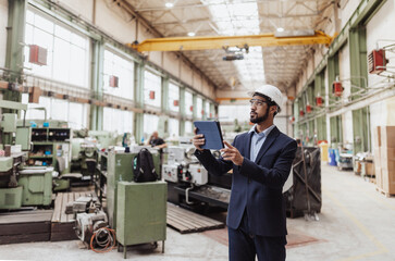 Engineering manager doing routine check up in industrial factory