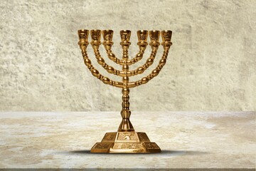A classic gold menorah with a background of the walls