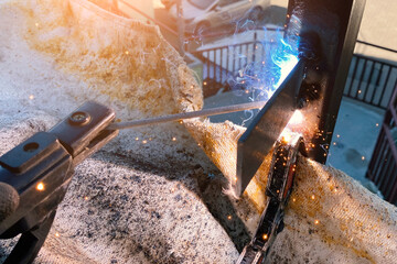 Electric arc welding in production, metal structure welding, large flash of light