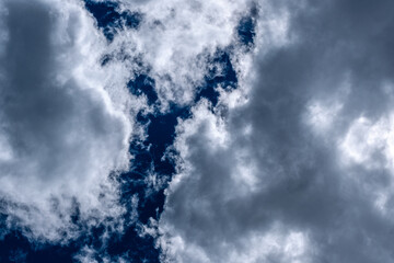 Dense clouds on a blue sky form patterns. 
