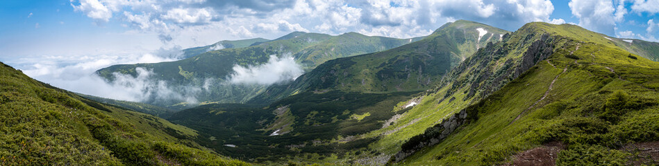 Fototapeta na wymiar Mountain landscape, picturesque mountain peaks in the summer with clouds, large panorama