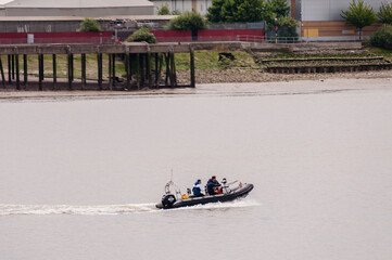 Fototapeta na wymiar Speed Boat trip in Thames Against Cloudy Sky, London on June 25, 2022 