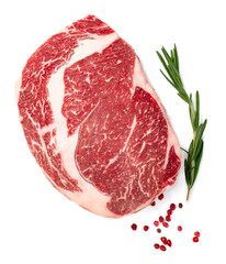 Raw rib eye steak of marbled beef with seasonings isolated on white