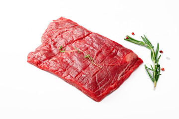 Raw flank steak or Outside skirt steak isolated on white color by seasonings and herbs - obrazy, fototapety, plakaty