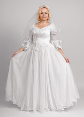 Fototapeta premium bride in long white dress, studio shot, full length