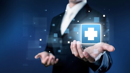 Businessman hand holding virtual medical health care icons. People health care awareness, life insurance business.