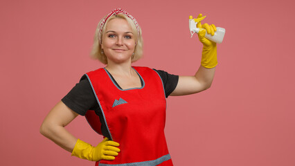 smiling maid in an apron and gloves with a spray bottle in her hands on a colored background