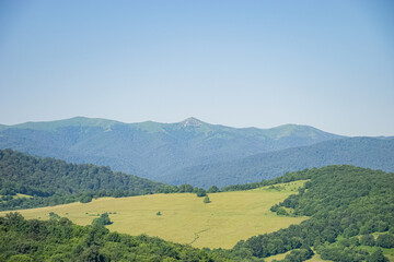 green landscape and blue sky in the mountains
