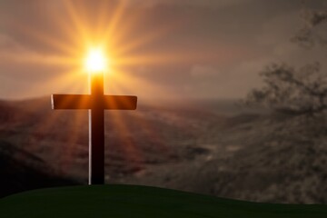 The concept of the Christian faith. Wooden cross, mountain and light