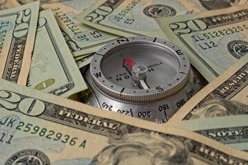 'Compass surrounded by  American twenty dollar bills'