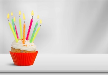Tasty sweet birthday cake with candles to celebrate a birthday