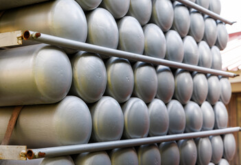 A lot of bottles filled with gas or gasoline are stacked in piles