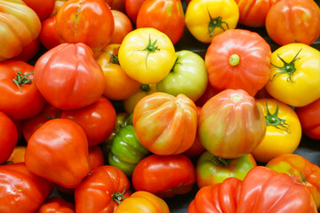 close up on fresh tomato pile as food background 