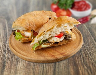 Tasty fresh sandwich with sauce on the table.