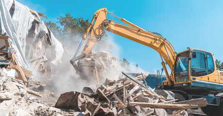 Demolition building. Excavator destroy old house.