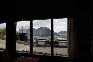 view of mount bromo seen from the hotel window, travelers enjoying the panorama of mount bromo