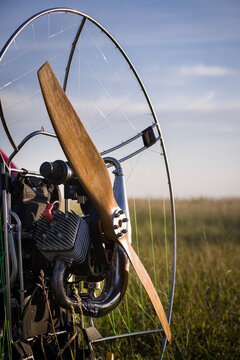 A closeup of a paramotor with a wooden propeller for individual paralet flights. Extreme sports. Selective focus