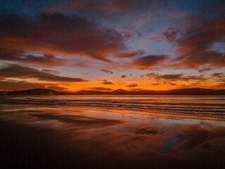 Winter sunrise at the seaside with high cloud and reflections