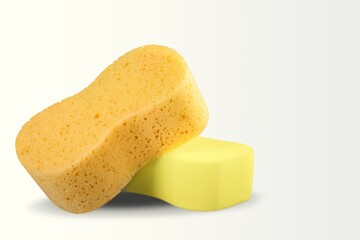 Yellow soft bath sponge on the desk