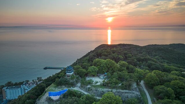 Aerial timelapse: Rotating around mountaintop Sumuto Castle at sunrise