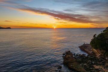 Sunrise over the sea with high cloud