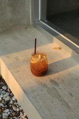 Espresso coffee with orange juice on iced. Fresh and sweet cold summer drink. Trendy iced coffee.