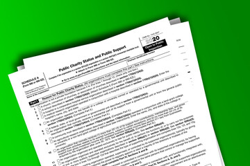 Fototapeta premium Form 990 or 990-EZ (Sch A) documentation published IRS USA 01.22.2021. American tax document on colored