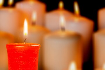 Set of burning candles in the dark against the background of blurry lights