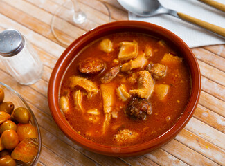 Madrid-style tripe served on table with serving pieces