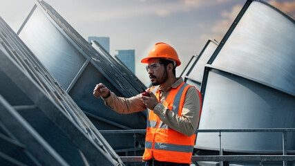 worker on a site. Engineer under checking the industry cooling tower air conditioner is water...