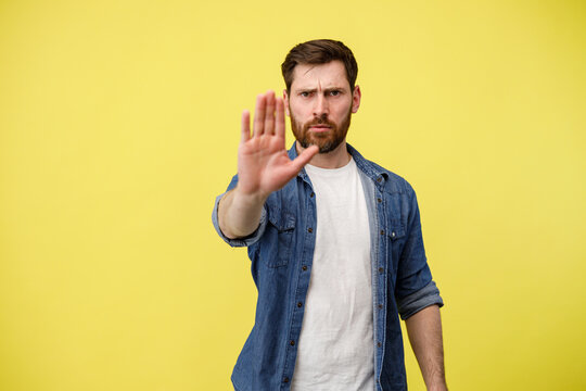 Man with his hand raised showing signal to stop against discrimination, violence or protest