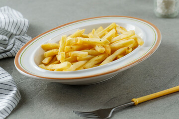 Portion of French Fries on WHite Plate, Close Up .