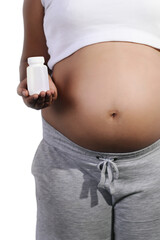 Pregnant woman latina holding pills bottle on right hand