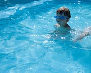 Fototapeta na wymiar outdoor swimming pool boy with swimming glasses