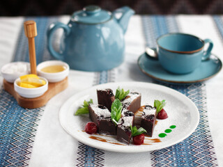 Chocolate dessert with mint on the white plate