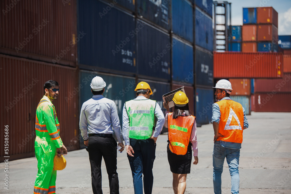 Poster manager standing and meeting with his staff in container depo company area. worker working checking 