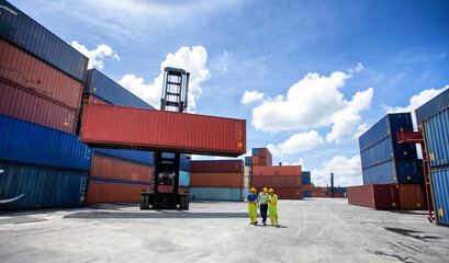 Manager standing and meeting with his staff in container depo company area. worker working checking...