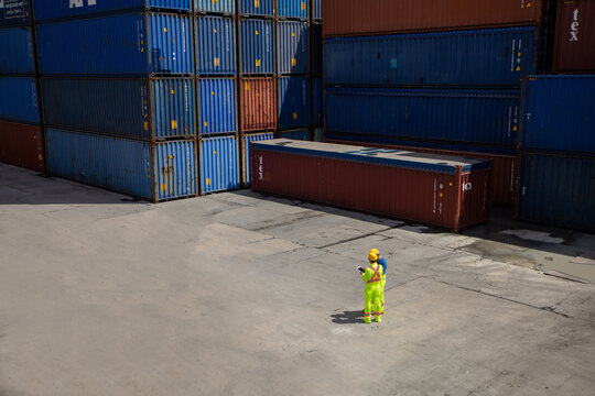 Group Workers People In Safety Uniforms And Hard Hats Work At Logistics Terminal With Many Stacks Of Containers ,Engineer Dock Worker Wear Safety Uniform Check Control Loading Freight Cargo Container