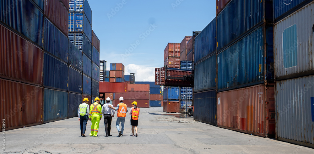 Aufkleber group workers people in safety uniforms and hard hats work at logistics terminal with many stacks of