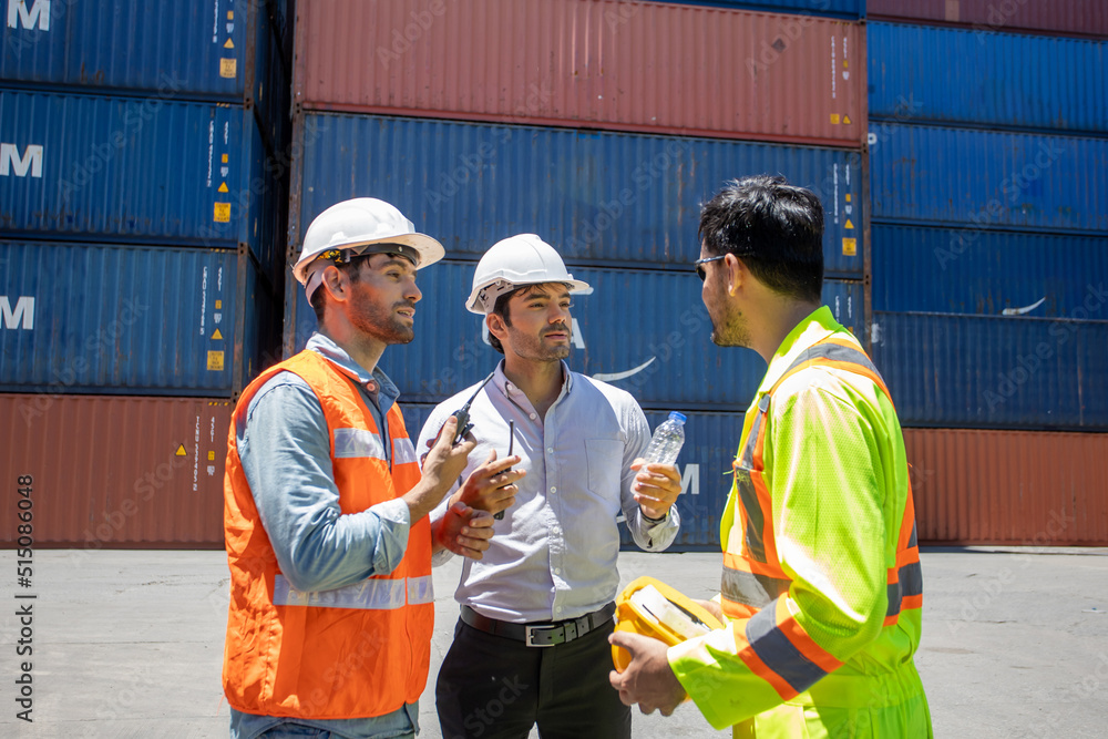 Poster manager standing and meeting with his staff in container depo company area. worker working checking 