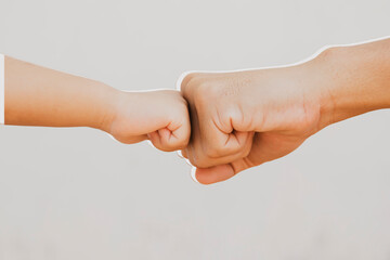 Father's big fist and son's little hand collide with each other, strength training and early childhood learning teaching : Clipping path