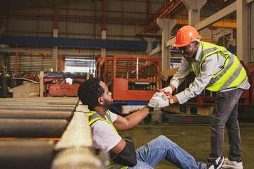 Caring friendship and sympathy for workers who are injured during work Concept : Male african american worker injured in arm wearing cast sits in pain gets sympathy for help to take sick leave to heal