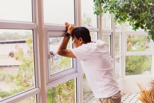 53 Year Old Asian Senior Man Put His Hand On His Head With Poor Mental Health Some Worry His Face Staring Out The Window Hoping To Solve Family Problems And Deteriorating Health. 